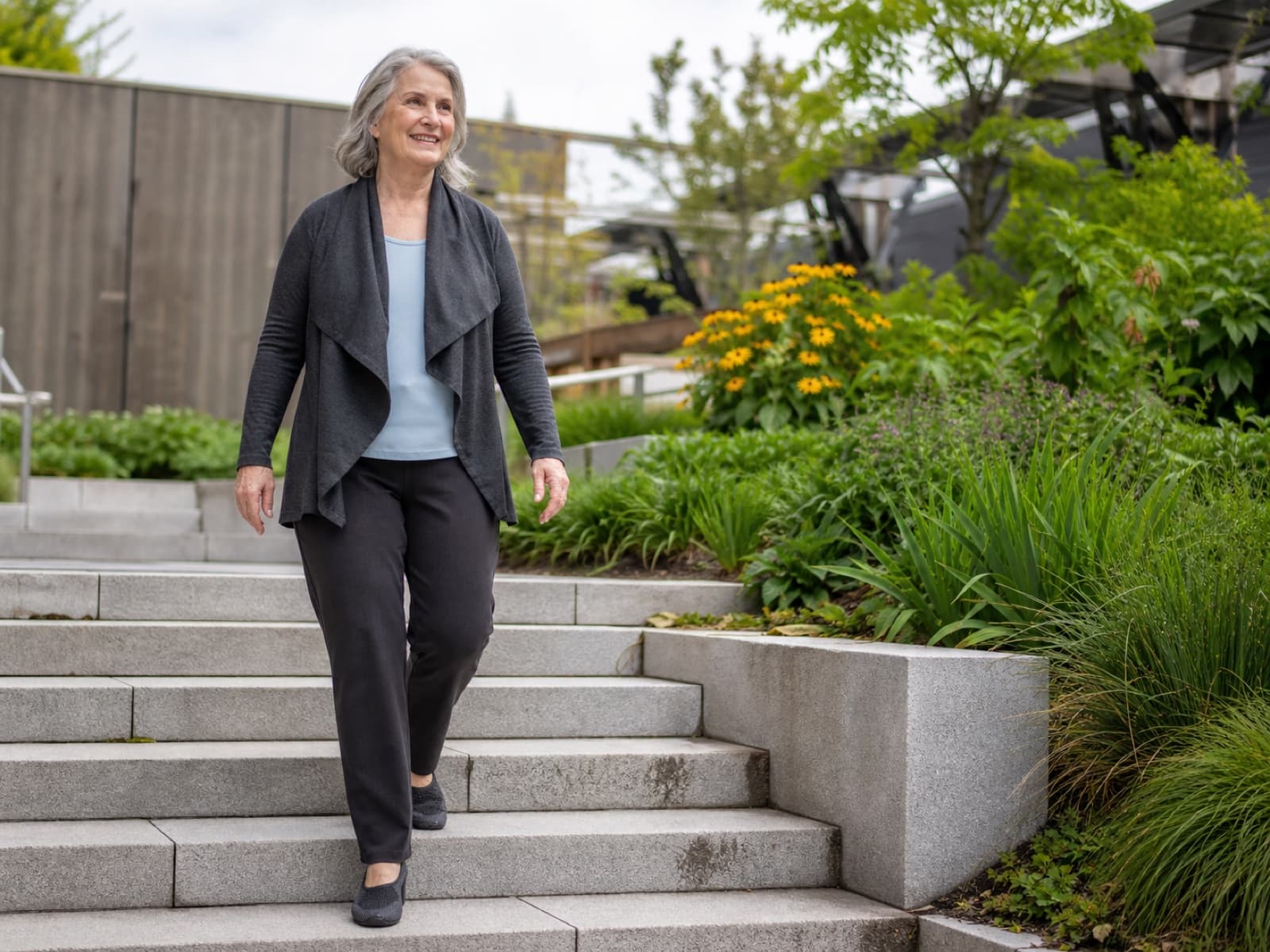 An older woman walking comfortably down outdoor steps